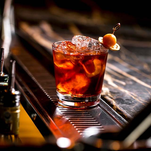 cocktail-glass-with-ice-cubes-garnished-with-dried-lemon-fruit cocktail-glass-with-ice-cubes-garnished-with-dried-lemon-fruit